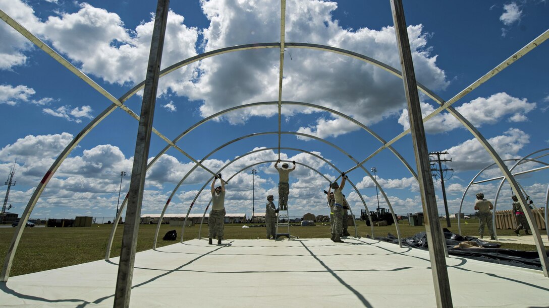 Airmen put up a tent at Battle Creek Air National Guard Base, Mich., June 7, 2017, during exercise Turbo Distribution 17-2. The U.S. Transportation Command exercise aims to assess the Joint Task Force Port Opening's ability to deliver and distribute cargo during humanitarian and disaster relief operations. The airmen are assigned to the 821st Contingency Response Group. Air Force photo by Airman 1st Class Gracie I. Lee