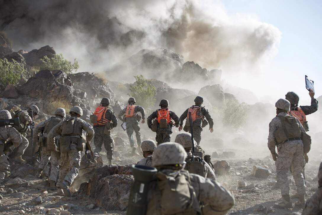 MARINE CORPS AIR GROUND COMBAT CENTER TWENTYNINE PALMS, California – Marines with Alpha Company, 1st Battalion, 8th Marine Regiment, begin their compnay reinfirced assault after a Bangalore explosive is set off Range 400 aboard the Marine Corps Air Ground Combat Center Twentynine Palms, California, May 8, 2017. The Marines conducted a company level assault reinforced by machine guns, vehicles, mortars and snipers as part of Integrated Training Exericse 3-17. Integrated Training Exercise is a training evolution conducted five times a year to enhance the lethality and co-operability between the four elements of a MAGTF. (U.S. Marine Corps photo by Cpl. Jesus Sepulveda Torres)