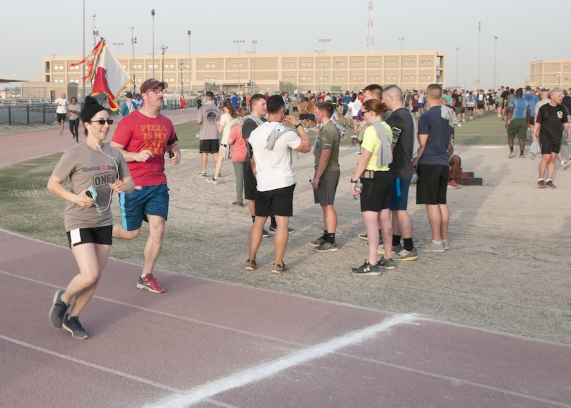 Sgt. Carissa Lombardo (left) and 1st. Lt. Joshua Tosi (right), of the 369th Sustainment Brigade cross the finish line in the inaugural Harlem Hellfighter 5K run, held at Camp Arifjan, Kuwait on June 2, 2017. The event was held to celebrate the 104th anniversary of the formation of the historic New York National Guard unit. The unit was given their historic nickname “Hellfighters” by their German opponents in WWI for their remarkable prowess on the battlefield. (U.S. Army photo by Sgt. Jeremy Bratt)