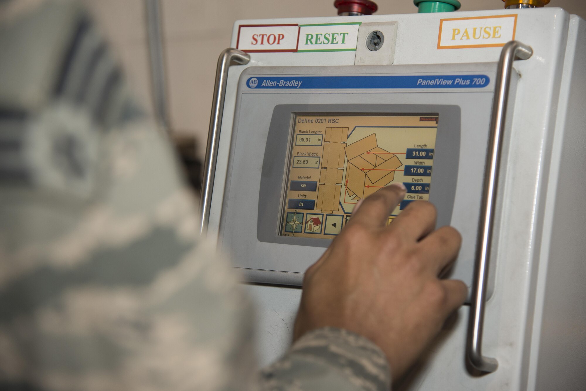 Senior Airman Gerard Pinckney, 436th Aerial Port Squadron traffic management specialist, inputs the desired box dimensions into a box-making machine Jan. 12, 2017, at the aerial port squadron on Dover Air Force Base, Del. The unit’s machine allows them to precisely craft cardboard boxes to meet shipping needs in the most cost-effective manner. (U.S. Air Force photo by Senior Airman Aaron J. Jenne)