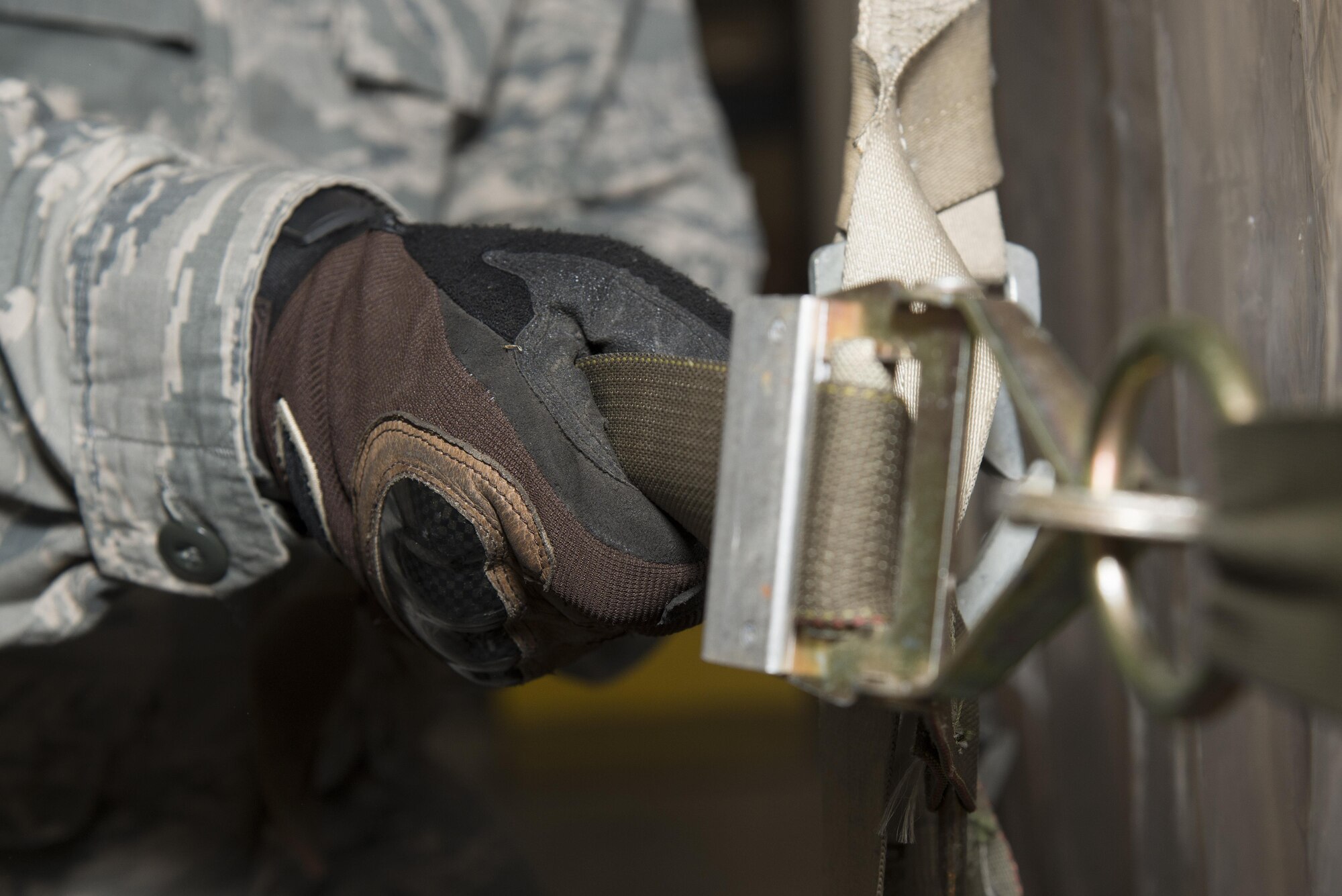 Staff Sgt. Travis Thompson, 436th Aerial Port Squadron cargo processing supervisor, tightens a strap on a pallet Jan. 12, 2017, at the aerial port on Dover Air Force Base, Del. Pallets are loaded to meet weight and size goals in order to maximize aircraft loads and weight distribution. (U.S. Air Force photo by Senior Airman Aaron J. Jenne)