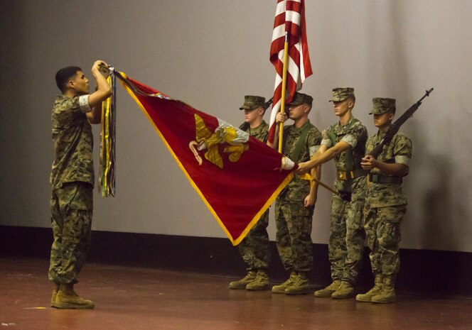 U.S. Marine Lance Cpl. Jeremy Godfrey assigned to I Company, 3d Battalion, 3d Marine Regiment, attaches a Southwest Asia Service streamer with two Bronze Stars to the Marine Corps Flag during the 75th anniversary ceremony at the base theater aboard Marine Corps Base Hawaii, Kaneohe Bay, May 31, 2017. 3d Battalion, 3d Marines has been active for a total of 75 years. (U.S. Marine Corps photo by Sgt. Ricky S. Gomez)