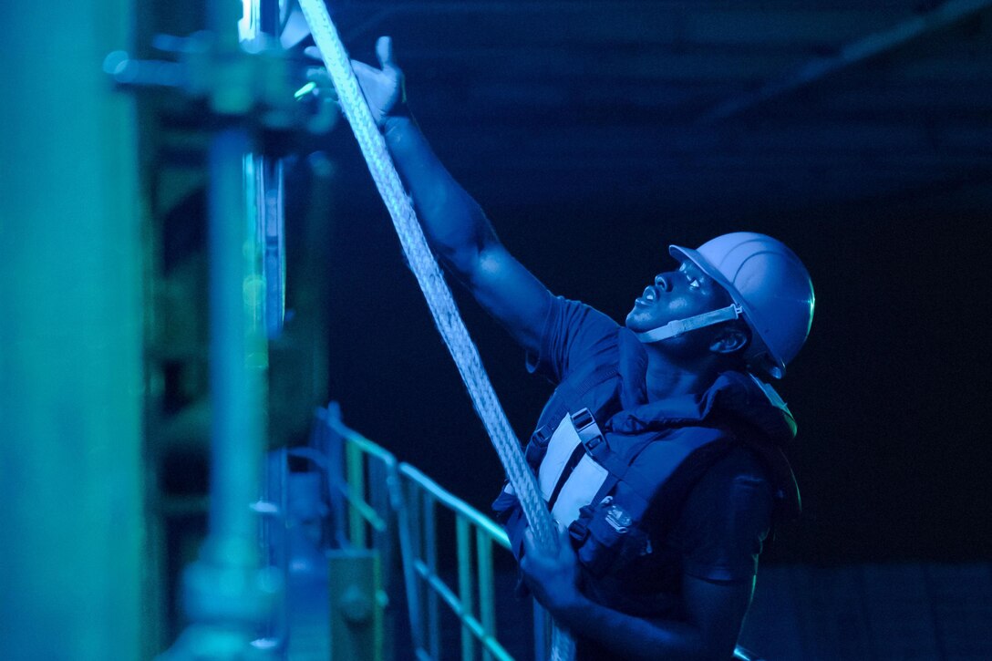 Navy Seaman Recruit Armonte Galloway heaves a line during well deck operations aboard the amphibious dock landing ship USS Ashland off the coast of Okinawa, Japan, June 10, 2017. The Ashland is operating in the Indo-Asia-Pacific region to enhance partnerships and serve as a ready-response force for any type of contingency. Navy photo by Petty Officer 3rd Class Jonathan Clay