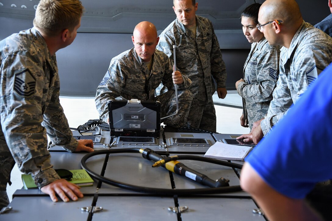 388th Maintenance Group Loading Standardization Crew Member Master Sgt. Jeffrey Taggart reads technical data during a validation and verification process of an ammuntion bulk loader used to load cannon rounds onto the F-35A Lightning II fighter aircraft, Hill Air Force Base, Utah. (U.S. Air Force photo/R. Nial Bradshaw)