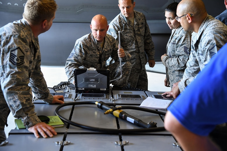 388th Maintenance Group Loading Standardization Crew Member Master Sgt. Jeffrey Taggart reads technical data during a validation and verification process of an ammuntion bulk loader used to load cannon rounds onto the F-35A Lightning II fighter aircraft, Hill Air Force Base, Utah. (U.S. Air Force photo/R. Nial Bradshaw)