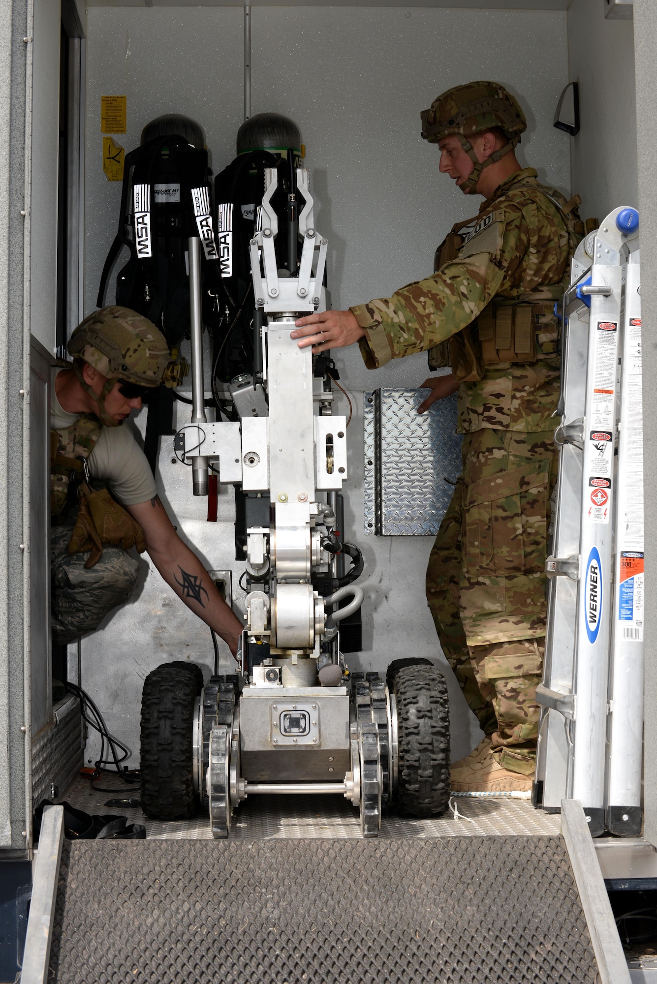 Members of the 28th Civil Engineer Squadron explosive ordnance disposal flight prepare to deploy an F-6/A robot during an exercise at Ellsworth Air Force Base, S.D., June 7, 2017. EOD responded to a simulated terrorist attack and used the robot to search and detonate a simulated explosive device during the exercise. (U.S. Air Force photo by Staff Sgt. Hailey Staker)