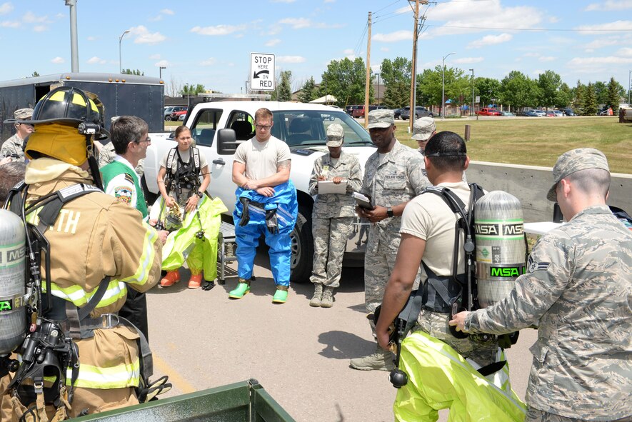 28th Bomb Wing Inspection Team members brief Airmen from the 28th Medical Operations Squadron bioenvironmental engineering response team during an exercise at Ellsworth Air Force Base, S.D., June 7, 2017. The purpose of the exercise was to evaluate emergency management response procedures in the event of a terrorist attack at the installation. (U.S. Air Force photo by Staff Sgt. Hailey Staker)