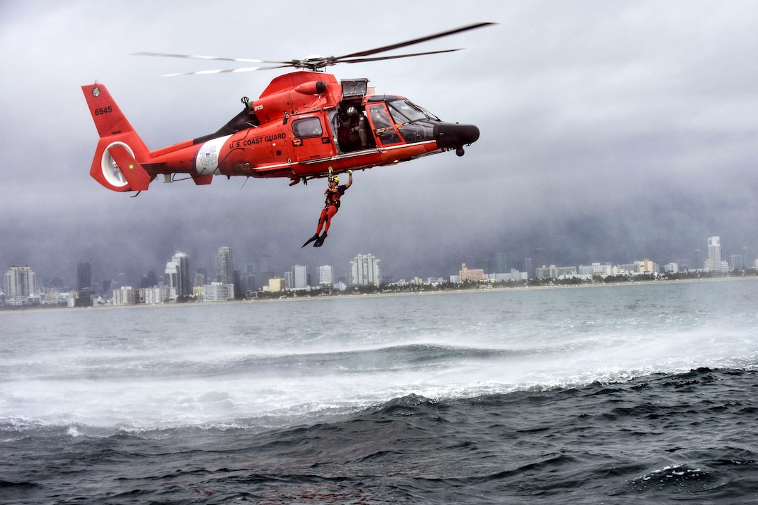 Coast Guard Petty Officer 3rd Class Bryan Evans, a rescue swimmer, conducts a free fall jump from a MH-65 Dolphin helicopter east of Miami Beach, Fla., June 6, 2017. Evans is assigned to Coast Guard Air Station Miami. Coast Guard photo by Petty Officer 3rd Class Eric D. Woodall