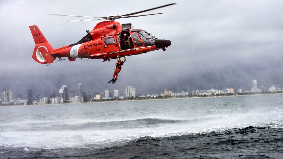 Coast Guard Petty Officer 3rd Class Bryan Evans, a rescue swimmer, conducts a free fall jump from a MH-65 Dolphin helicopter east of Miami Beach, Fla., June 6, 2017. Evans is assigned to Coast Guard Air Station Miami. Coast Guard photo by Petty Officer 3rd Class Eric D. Woodall