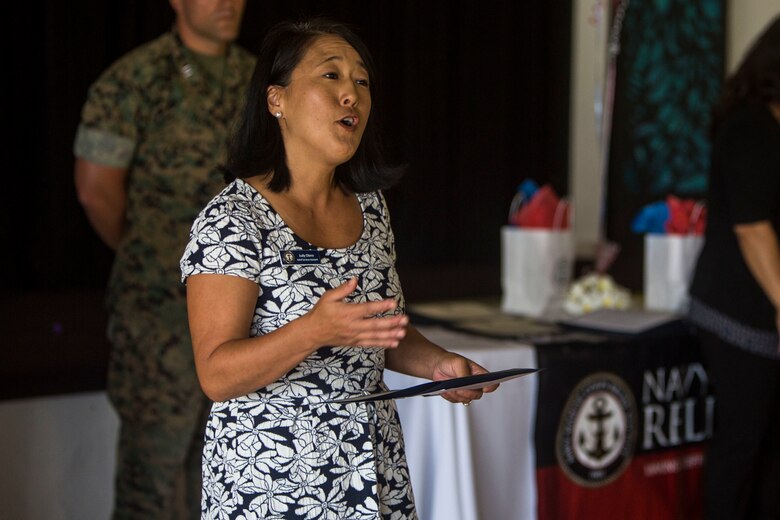 Judy Otero, a relief service assistant with the Navy-Marine Corps Relief Society, congratulates service members on their efforts providing donations during the Active Duty Fund Drive awards ceremony at the Officers’ Club ballroom aboard Marine Corps Base Hawaii on June 8, 2017. The Navy-Marine Corps Relief Society hosted this ceremony to recognize the units that donated over $190,000 to the Active Duty Fund Drive. (U.S. Marine Corps photo by Lance Cpl. Isabelo Tabanguil)