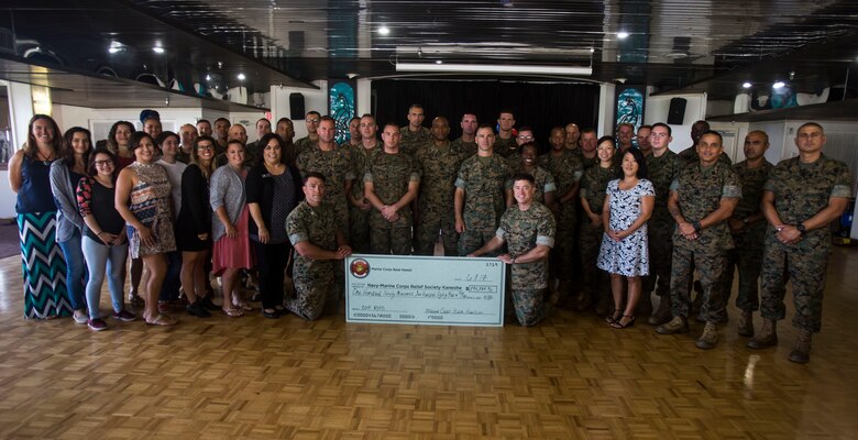 Service members and MCB Hawaii personnel pose for a group photo during the Active Duty Fund Drive awards ceremony at the Officers’ Club ballroom aboard Marine Corps Base Hawaii on June 8, 2017. The Navy-Marine Corps Relief Society hosted this ceremony to recognize the units that donated over $190,000 to the Active Duty Fund Drive. (U.S. Marine Corps photo by Lance Cpl. Isabelo Tabanguil)