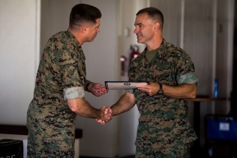 Col. Sean Killeen, commanding officer, Marine Corps Base Hawaii, delivers a certificate to Lt. Col. Steven Eastin, commanding officer, 3rd Battalion, 3rd Marine Regiment, for his unit during the Active Duty Fund Drive awards ceremony at the Officers’ Club ballroom aboard MCB Hawaii on June 8, 2017. The Navy-Marine Corps Relief Society hosted this ceremony to recognize the units that donated over $190,000 to the Active Duty Fund Drive. (U.S. Marine Corps photo by Lance Cpl. Isabelo Tabanguil)