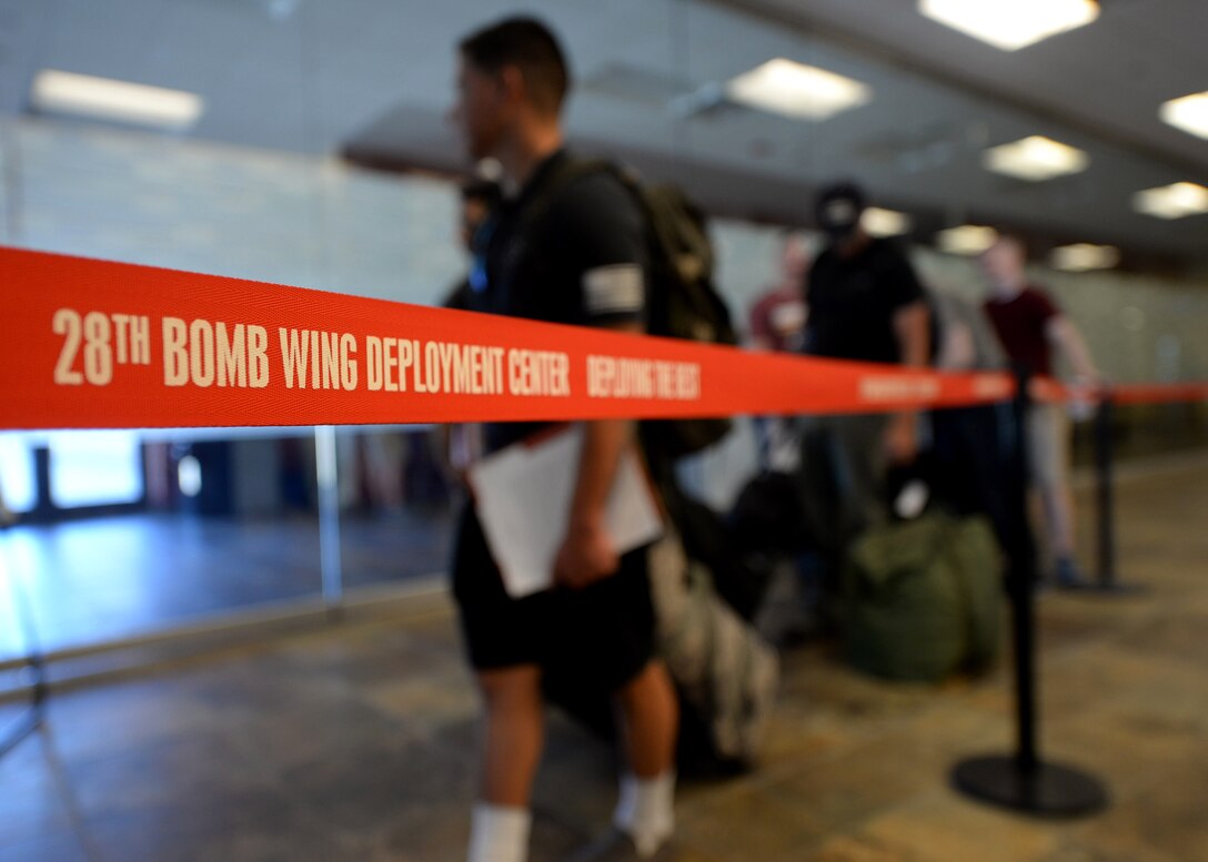 Airmen from the 28th Bomb Wing prepare to go through the deployment processing line at the Installation Deployment Center at Ellsworth Air Force Base, S.D., June 3, 2017. Approximately 100 Ellsworth Airmen deployed to Royal Air Force Fairford, United Kingdom, in support of multiple joint, multinational exercises. (U.S. Air Force photo by Senior Airman Denise M. Jenson)