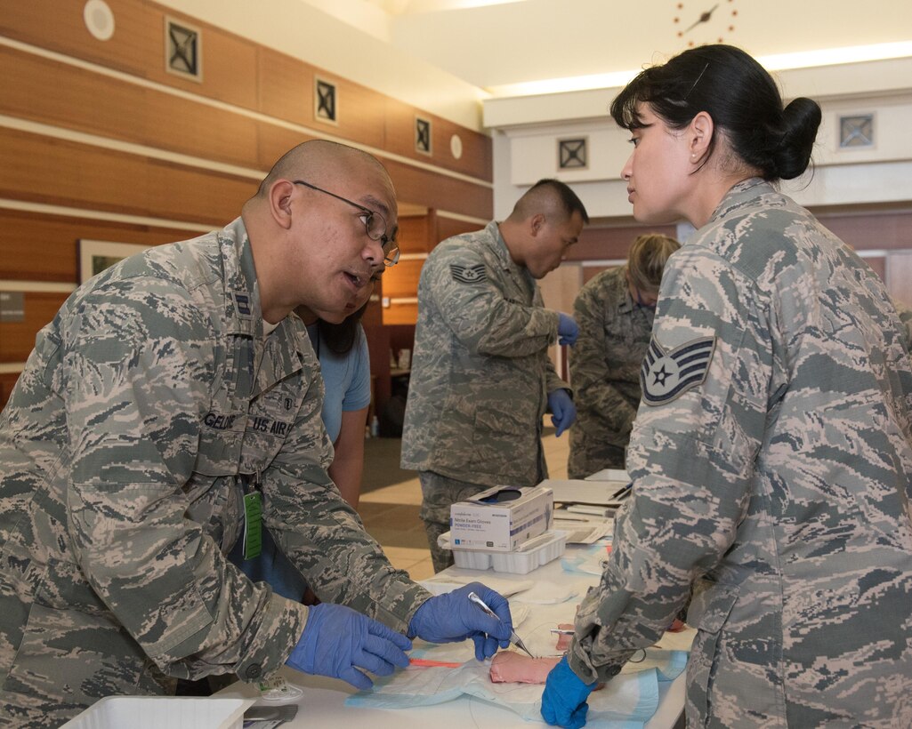 U.S. Air Force Capt. Shunrie Geldore, 36th Medical Group physician’s assistant, and U.S. Air Force Staff Sgt. Tiffany Fowler, an aerospace medic assigned to the 159th MDG, Naval Air Station Joint Reserve Base New Orleans, La., practice suturing during a 36th MDG training day June 8, 2017, at Andersen Air Force Base, Guam. To maintain proficiency, the 36th and 159th Medical Groups trained readiness skills that are not often practiced in a clinical setting. (U.S. Air Force photo by Airman 1st Class Jacob Skovo)