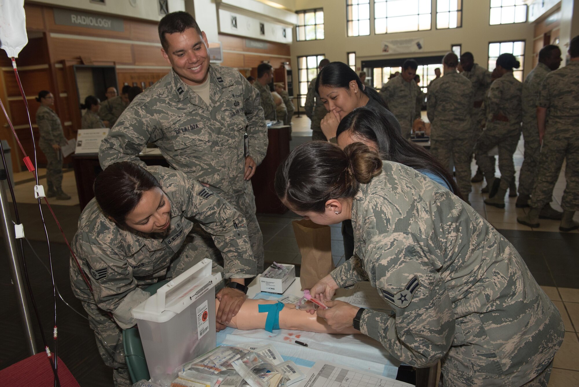 U.S. Airmen assigned to the 36th Medical Group simulate drawing blood during a training day June 8, 2017, at Andersen Air Force Base, Guam. In addition to drawing blood, Airmen from the 36th MDG and 159th MDG, Naval Air Station Joint Reserve Base New Orleans, La., practiced skills such as suturing, inserting catheters with sterile technique, preparing casts and more. (U.S. Air Force photo by Airman 1st Class Jacob Skovo)