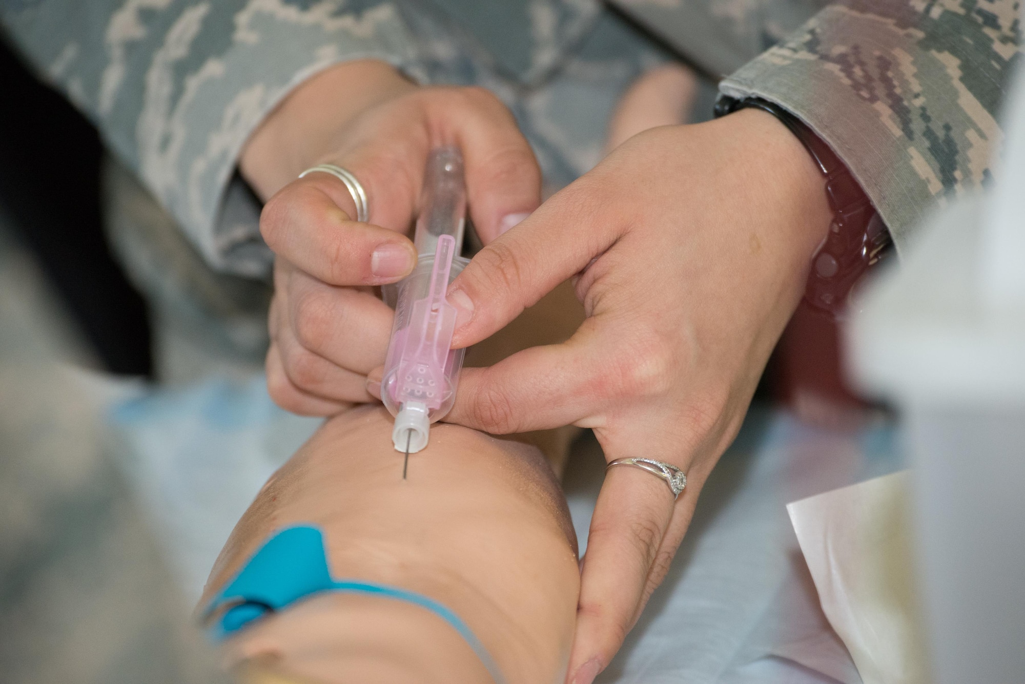A U.S. Airman simulates drawing blood during a 36th Medical Group training day June 8, 2017, at Andersen Air Force Base, Guam. In addition to drawing blood, the Airmen from the 36th MDG and 159th MDG, Naval Air Station Joint Reserve Base New Orleans, La., practiced skills such as suturing, inserting catheters with sterile technique, preparing casts and more. (U.S. Air Force photo by Airman 1st Class Jacob Skovo)