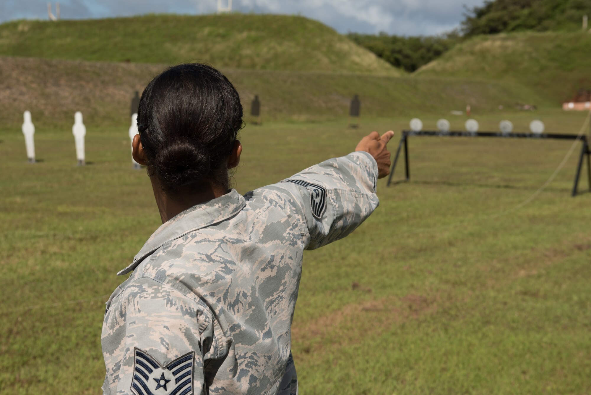 U.S. Air Force Tech. Sgt. Yerida Vazquez, 36th Security Forces Squadron NCO in charge of combat arms, visualizes making a single-arm pistol shot before a shooting competition April 29, 2017, at Naval Computer and Telecommunications Station, Guam. During the relay stage of the shooting competition, four-person teams raced against the clock as they switched between the rifle, shotgun and two pistol stages. (U.S. Air Force photo by Airman 1st Class Jacob Skovo)