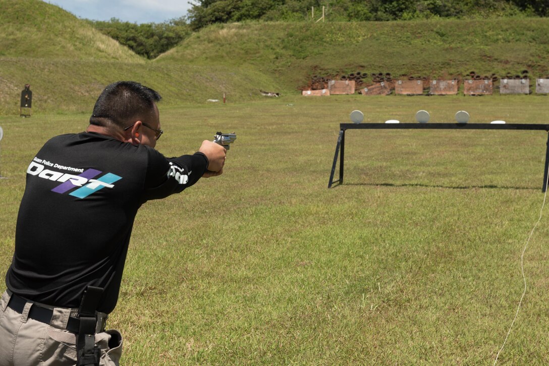 Capt. Scott Wade, Guam Police Department, fires a handgun April 29, 2017, at Naval Computer and Telecommunications Station, Guam. Members of the GPD hosted this friendly shoot-off to bring law enforcement from around the island together. (U.S. Air Force photo by Airman 1st Class Jacob Skovo)