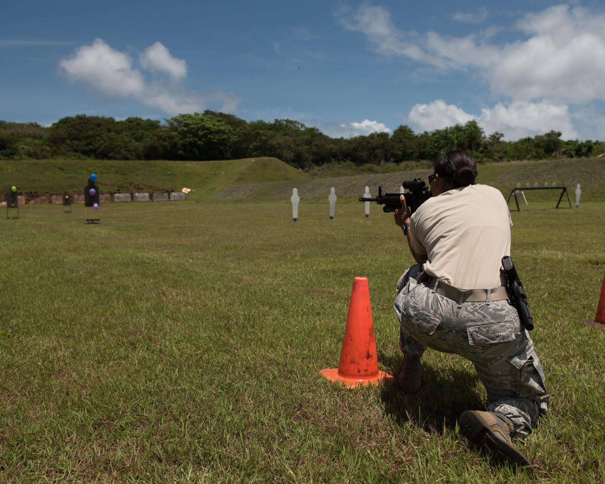 U.S. Air Force Tech. Sgt. Yerida Vazquez, 36th Security Forces Squadron NCO in charge of combat arms, fires an M4 carbine at balloon targets April 29, 2017, at Naval Computer and Telecommunications Station, Guam. The balloons, varying sizes and movement in the wind, increased the difficulty of the rifle portion of the three gun shoot-off. (U.S. Air Force photo by Airman 1st Class Jacob Skovo)
