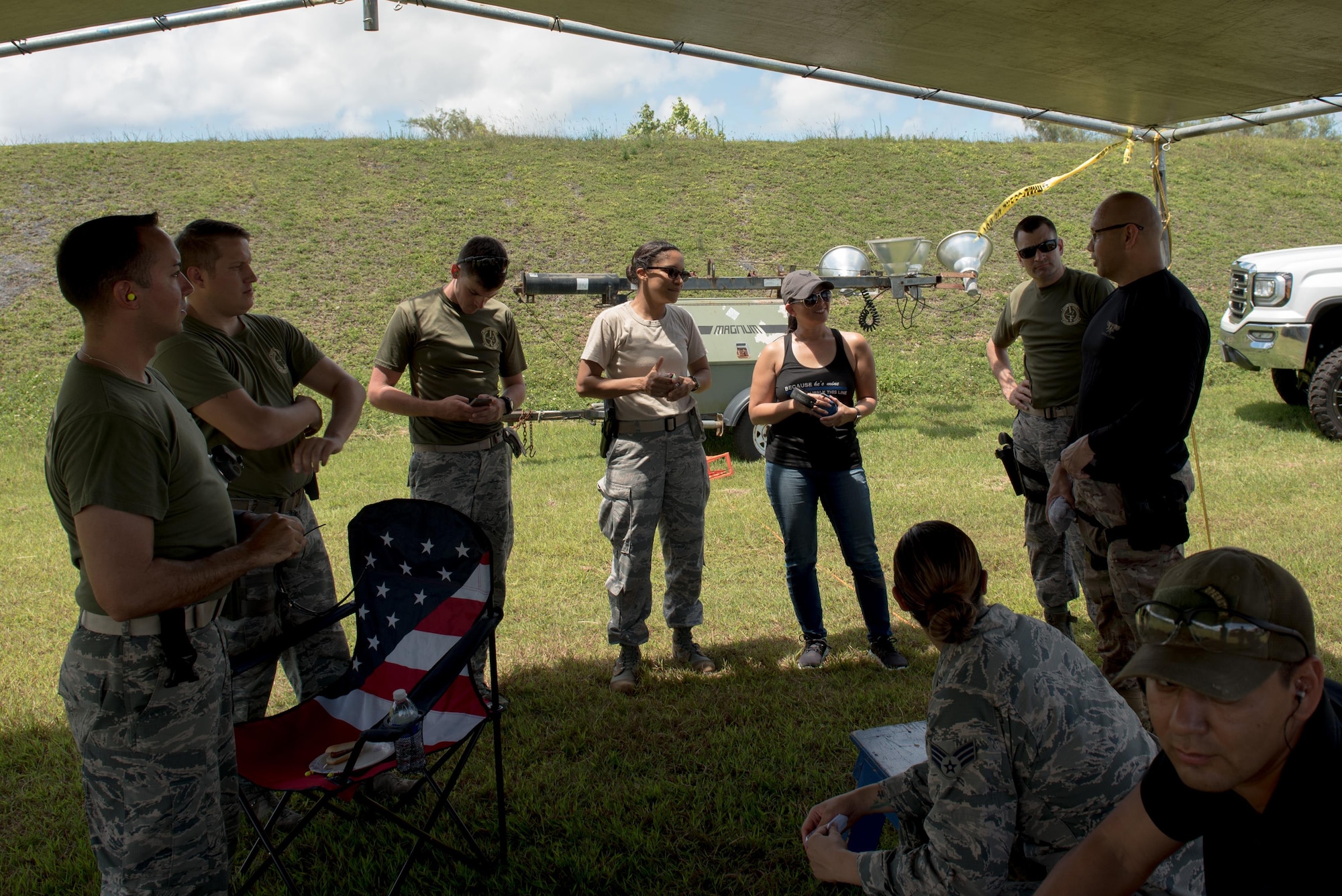 Airmen from the 36th Security Forces Squadron speak with the Guam Police Department Chief of Police Joseph Cruz April 29, 2017, at Naval Computer and Telecommunications Station, Guam. Members of the GPD hosted this friendly shoot-off to bring law enforcement from around the island together. (U.S. Air Force photo by Airman 1st Class Jacob Skovo)
