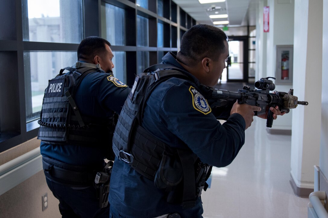 Members with the 36th Security Forces Squadron search for a simulated active shooter during an emergency management exercise May 11, 2017, at Andersen Air Force Base, Guam. The exercise tested capabilities of emergency responders and support agencies. (U.S. Air Force photo by Airman 1st Class Jacob Skovo)
