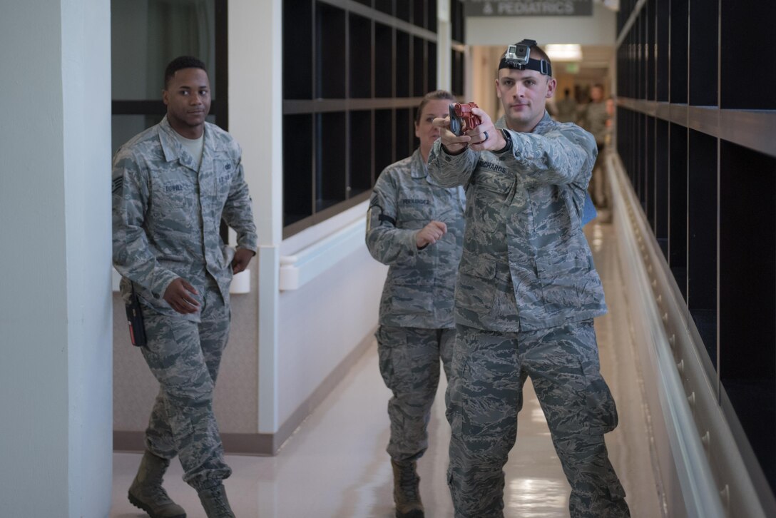 U.S. Air Force 1st Lt. Charles Richards fires a simulated handgun during an emergency management exercise May 11, 2017, at Andersen Air Force Base, Guam. Richards played the role of an active shooter during an emergency management exercise organized by the 36th Wing Inspector General. (U.S. Air Force photo by Airman 1st Class Jacob Skovo)
