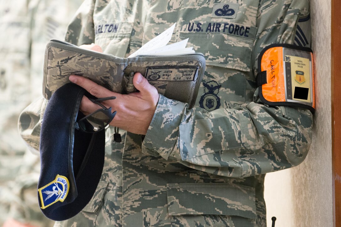 U.S. Air Force Master Sgt. Justin Carlton, 36th Security Forces wing inspection team member, notes the performance of Airmen during an emergency management exercise May 11, 2017, at Andersen Air Force Base, Guam. WIT members are highly-skilled members of their career field tasked to evaluate their unit’s  response to exercise scenarios. (U.S. Air Force photo by Airman 1st Class Jacob Skovo)