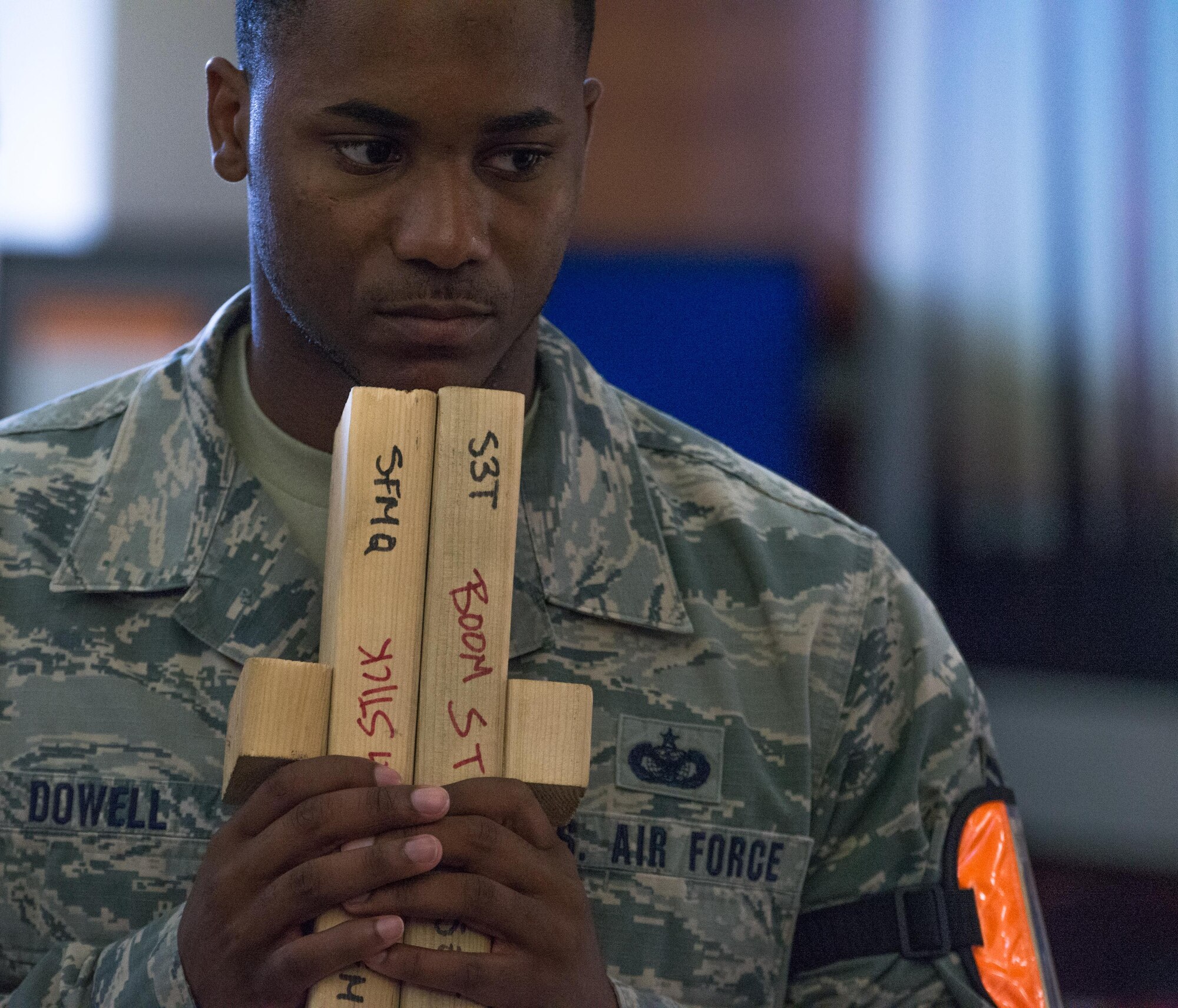 U.S. Air Force Staff Sgt. Rodney Dowell, 36th Security Forces Squadron wing inspection team member, holds boom sticks during an emergency management exercise May 11, 2017 at Andersen Air Force Base, Guam. Boom sticks are used to produce loud percussive sounds, similar to that of gunfire, to enhance the realism of simulated active-shooter scenarios. (U.S. Air Force photo by Airman 1st Class Jacob Skovo)