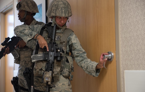 Staff Sgt. Bianca Doblado, 36th Security Forces Squadron, searches for threats during an emergency management exercise May 11, 2017, at Andersen Air Force Base, Guam. When known active shooters are no longer a threat, SFS Airmen clear the building to ensure the area is safe. (U.S. Air Force photo by Airman 1st Class Jacob Skovo)
