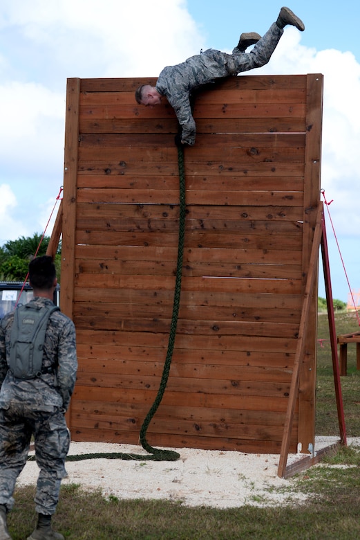 U.S. Air Force Capt. Kyle Buss, 36th Security Forces Squadron operations officer, climbs over a wall during the second annual Security Forces Advanced Combat Skills Assessment June 6, 2017 at Andersen Air Force Base, Guam. The mental and physical challenge portion tested basic combat skills and knowledge of competitors at different stations along an obstacle course through the jungle. (U.S. Air Force photo by Airman 1st Class Gerald R. Willis)