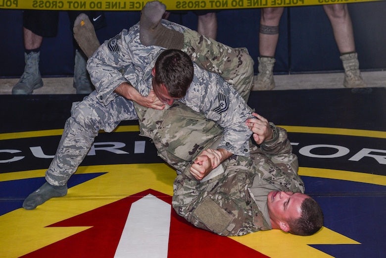 A U.S Soldier attempts to put a U.S. Airman into a submission during the second annual Security Forces Advanced Combat Skills Assessment June 9, 2017, at Andersen Air Force Base, Guam. Over 100 Airmen and Soldiers throughout U.S. Pacific Command’s area of responsibility gathered to compete in five different categories: weapons, tactics, combat fitness, mental and physical challenge, and military working dog handling. (U.S. Air Force photo by Airman 1st Class Christopher Quail)