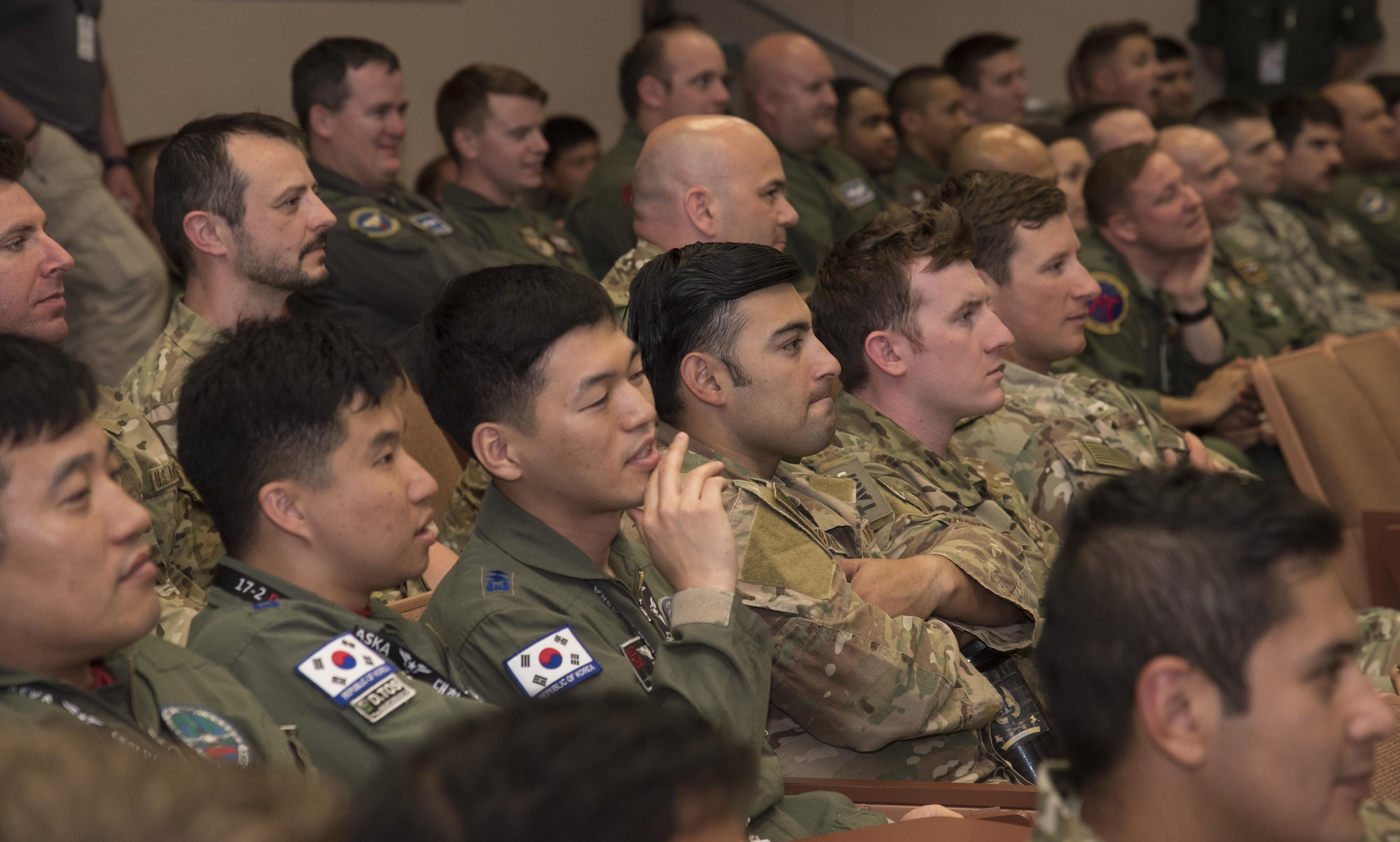 Pilots listen to a mass briefing during the large force exercise Red Flag-Alaska 17-2 at Eielson Air Force Base, Alaska, June 7, 2017. U.S. service members from all branches and several air forces from other countries including the Royal Thai, Republic of Korea, Japan Air Self-Defense Force, Finland, Denmark and Israel's air forces. They worked together to improve their tactical fluidity as they work cohesively, executing the objective. Exercises of this nature are vital to maintaining peace and stability in the Indo-Asia-Pacific theatre and signifies our continued commitment to the Pacific. (U.S. Air Force photo by Airman 1st Class Sadie Colbert)