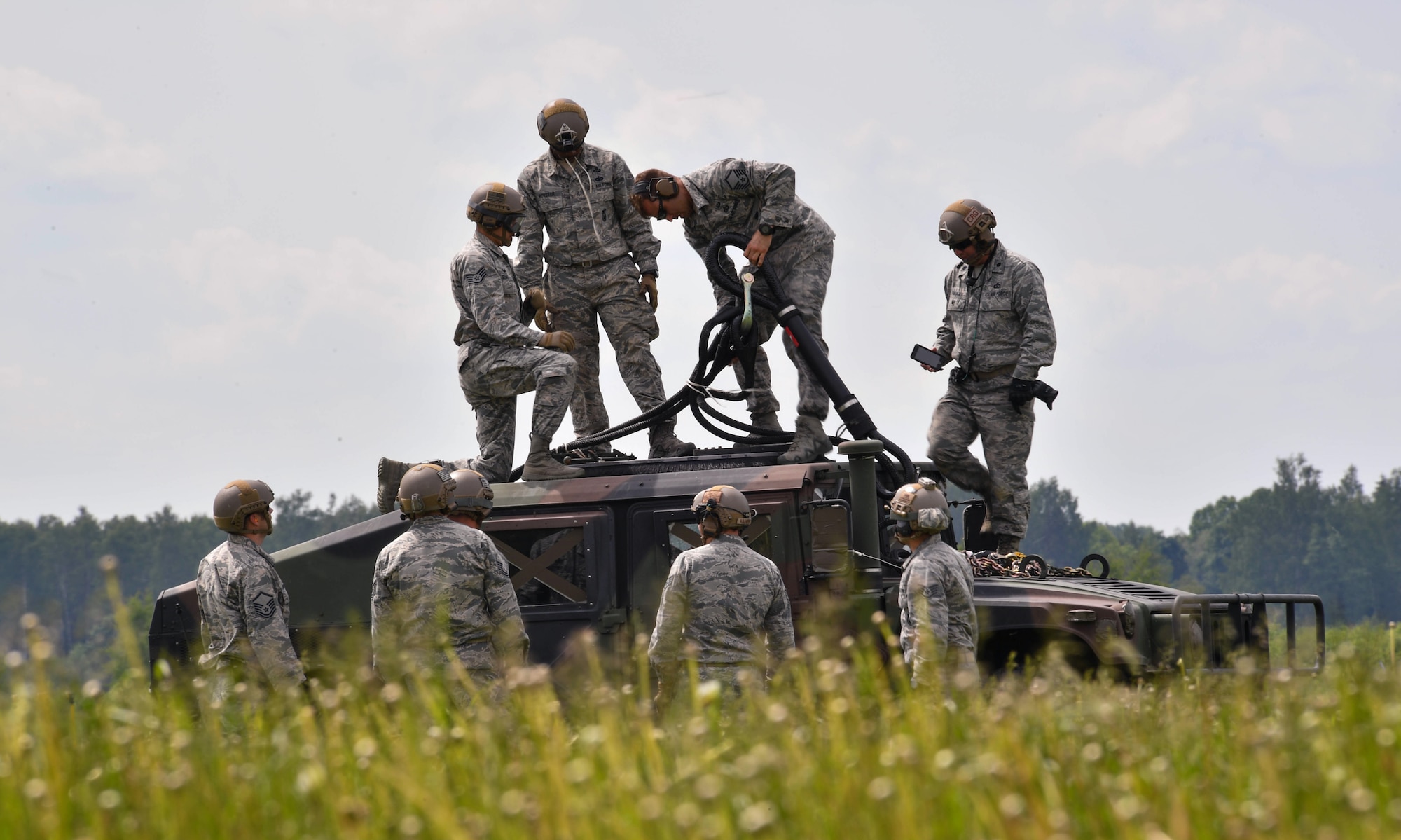 U.S. Air Force Airmen assigned to the 435th Contingency Response Group prepare a high mobility multipurpose wheeled vehicle to be picked up by a U.S. Army CH-47 Chinook for the 435th CRG’s sling load operation during exercise Saber Strike 17 at Lielvarde Air Base, Latvia, June 10, 2017. The 435th CRG Airmen practiced rigging the HUMVEE and a bundle multiple times to practice for a sling load operation. Saber Strike 17 continues to increase participating nations’ capacity to conduct a full spectrum of military operations. (U.S Air Force photo by Senior Airman Tryphena Mayhugh)