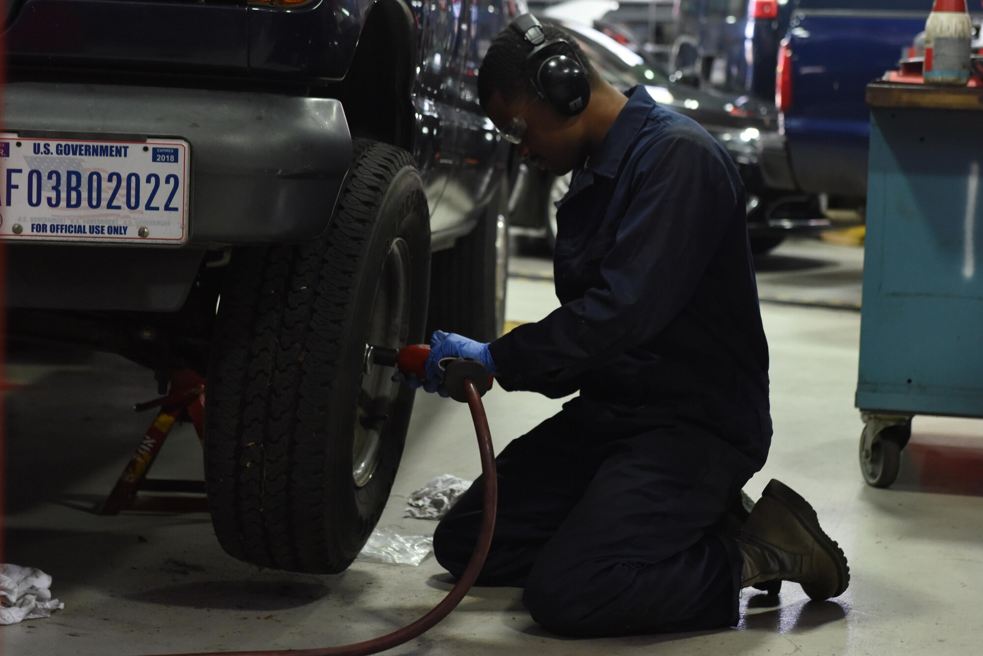 A Vehicle Maintainer from the 48th Logistical Readiness Squadron removes a front tire from a police car at Royal Air Force Lakenheath, June 7. Vehicle and Vehicular Equipment Maintainers ensure that all vehicles used by security forces, ground crew and Vehicle Operators function are in working order. (U.S. Air Force photo/Airman 1st Class John A. Crawford)