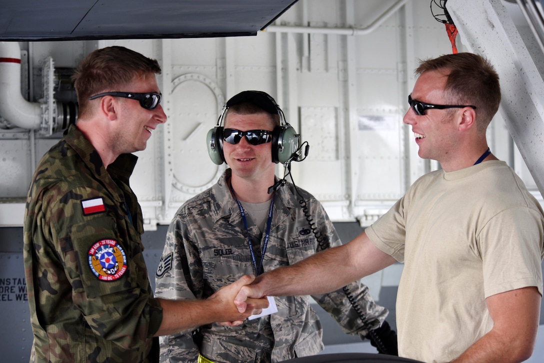 Air Force Master Sgt. Jacob Wavrin, right, Air Force Staff Sgt. James Sidler, center, talk with Polish air force Staff Sgt. Radoslaw Tyc, left, during Baltic Operations 2017 at Powidz Air Base, Poland, June 5, 2017. Wavrin is a crew chief and Sidler is an aircraft mechanic assigned to the 459th Aircraft Maintenance Squadron. Air Force photo by Staff Sgt. Jonathan Snyder