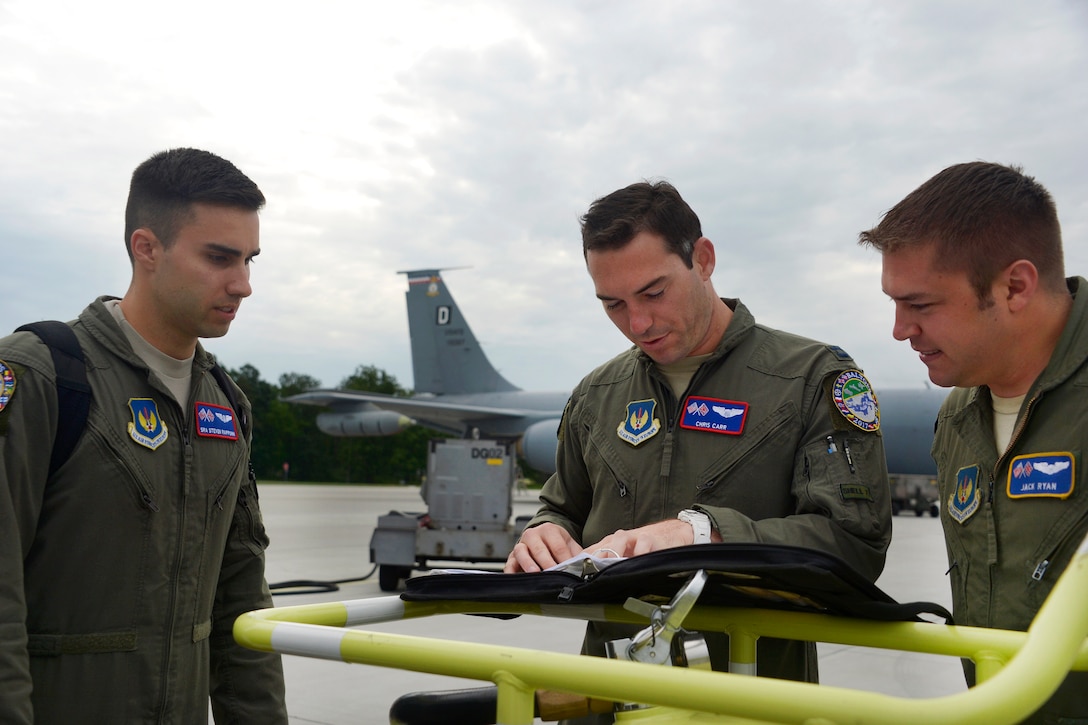 Air Force Capt. Chris Carr, center, conducts a crew briefing with Capt. Jack Ryan, right, and Senior Airman Steven Rappuhn before boarding a KC-135R Stratotanker aircraft during Baltic Operations 2017 at Powidz Air Base, Poland, June 6, 2017. Carr is a pilot, Ryan is a co-pilot, and Rappuhn is a boom operator assigned to the 351st Air Refueling Squadron. Air Force photo by Staff Sgt. Jonathan Snyder