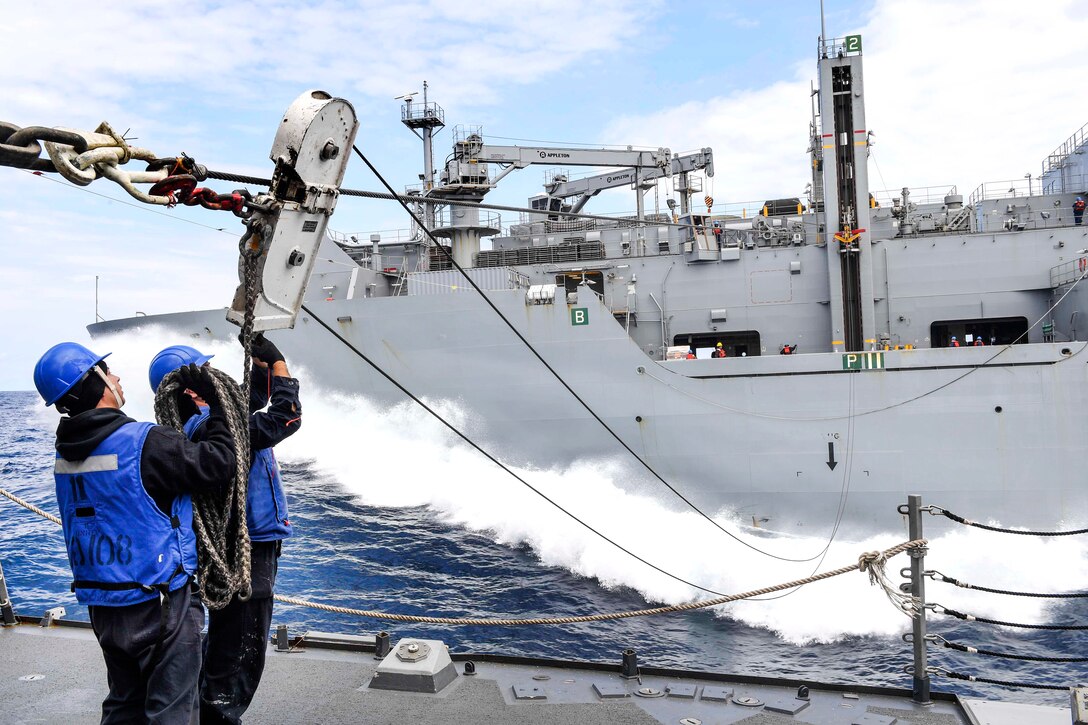 Navy Seaman Christopher Tittle, right, and Petty Officer 2nd Class Jason Arroyo secure excess line from the Lewis and Clark-class dry cargo ship USNS Charles Drew during a replenishment-at-sea aboard the Arleigh Burke-class guided-missile destroyer USS Wayne E. Meyer in the western Pacific Ocean, June 3, 2017. Navy photo by Petty Officer 3rd Class Kelsey L. Adams 