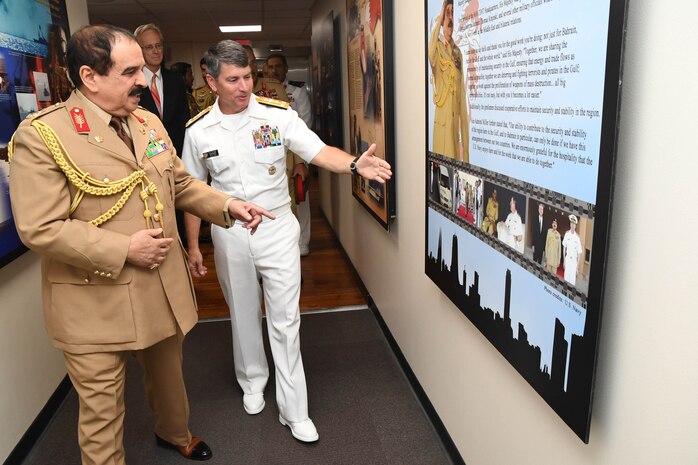 His Majesty, King Hamad bin Isa Al Khalifa, the King of the Kingdom of Bahrain and Vice Adm. Kevin M. Donegan Commander, U.S. 5th Fleet talk about a poster of his last visit to U.S. Naval Forces Central Command headquarters during a visit to discuss operations in the U.S. 5th Fleet area of operations and coalition operations to defeat ISIS, June 12. The King was accompanied by two of his sons, His Highness Brig. Gen. Shaikh Nasser bin Hamad Al Khalifa, Commander of the Royal Guard, and His Highness Maj. Shaikh Khaled bin Hamad Al Khalifa, Commander of the Royal Guard Special Force; the Commander-in-Chief of the Bahrain Defense Force, His Excellency Field Marshal Shaikh Khalifa bin Ahmed Al Khalifa; and the Commander of the Bahraini Royal Navy, His Excellency Rear Adm. Shaikh Khalifa bin Abdullah Al Khalifa. Bahrain has been a partner with the United States in regional maritime security for nearly 70 years. 