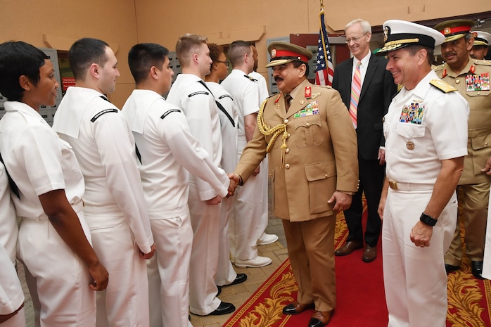 His Majesty, King Hamad bin Isa Al Khalifa, the King of the Kingdom of Bahrain, shakes hands with Sailors during a visit to discuss operations in the U.S. 5th Fleet area of operations and coalition operations to defeat ISIS, June 12. The King was accompanied by two of his sons, His Highness Brig. Gen. Shaikh Nasser bin Hamad Al Khalifa, Commander of the Royal Guard, and His Highness Maj. Shaikh Khaled bin Hamad Al Khalifa, Commander of the Royal Guard Special Force; the Commander-in-Chief of the Bahrain Defense Force, His Excellency Field Marshal Shaikh Khalifa bin Ahmed Al Khalifa; and the Commander of the Bahraini Royal Navy, His Excellency Rear Adm. Shaikh Khalifa bin Abdullah Al Khalifa. Bahrain has been a partner with the United States in regional maritime security for nearly 70 years.
