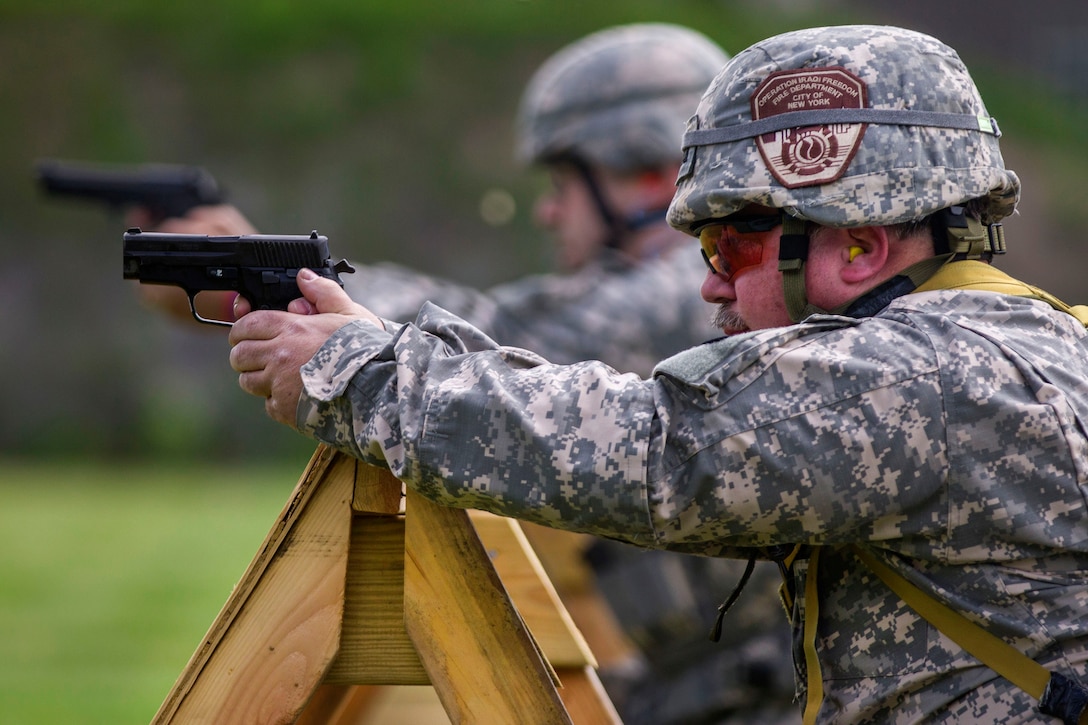 New York Army National Guardsmen fire their M9 pistols during competition at Camp Smith Training Site, N.Y., June 3, 2017. Army National Guard photo by Spc. Jonathan Pietrantoni