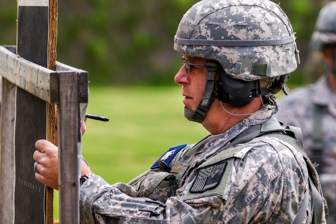 A New York Army National Guardsman checks his target during competition at Camp Smith Training Site, N.Y., June 3, 2017. Army National Guard photo by Spc. Jonathan Pietrantoni