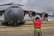 Staff Sgt. Matthew Fisher, 514th Aircraft Maintenance Squadron, Air Mobility Command, marshals a C-17 Globemaster III with the 305th Air Mobility Wing at the Combat Readiness Training Center at Gulfport, Miss., in support of Crisis Response '17 March 5, 2017. Close to 700 Air Mobility Command Airmen with the 514th Air Mobility Wing, the 305th Air Mobility Wing, the 87th Air Base Wing, and the 621st Contingency Response Wing are participating in the mobilization exercise. (U.S. Air Force photo by Master Sgt. Mark C. Olsen/Released)