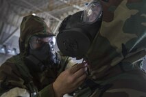 Air Mobility Command Airmen perform a buddy check on each other to ensure that their Mission-Oriented Protective Posture gear is put on correctly during Chemical, Biological, Radiological and Nuclear training at the Combat Readiness Training Center at Gulfport, Miss., in support of Crisis Response '17 March 5, 2017. Close to 700 Airmen with the 514th Air Mobility Wing, the 305th Air Mobility Wing, the 87th Air Base Wing, and the 621st Contingency Response Wing are participating in the mobilization exercise Crisis Response '17. (U.S. Air Force photo by Master Sgt. Mark C. Olsen/Released)