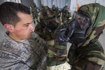 Staff Sgt. Henry McKay, left, 514th Emergency Management, Air Mobility Command, inspects an Airman’s Mission-Oriented Protective Posture gear during Chemical, Biological, Radiological and Nuclear training at the Combat Readiness Training Center at Gulfport, Miss., in support of Crisis Response '17 March 5, 2017. Close to 700 Airmen with the 514th Air Mobility Wing, the 305th Air Mobility Wing, the 87th Air Base Wing, and the 621st Contingency Response Wing are participating in the mobilization exercise Crisis Response '17. (U.S. Air Force photo by Master Sgt. Mark C. Olsen/Released)
