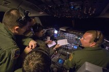 Maj. Chris Nedved, left, wing inspection team, 305th Air Mobility Wing, Capt. Dan O’Hara, second from left, 1st Lt. Sean O’Donnell, right, and Tech. Sgt. Ricky Rivera, engineer, all with 76th Air Refueling Squadron, 514th Air Mobility Wing, prepares for an early morning F-22 Raptor refueling mission over the Florida coast March 7, 2017. The 514th and the 305th which are located at Joint Base McGuire-Dix-Lakehurst, N.J., is participating in the mobilization exercise Crisis Response '17 at the Combat Readiness Training Center at Gulfport, Miss. (U.S. Air Force photo by Master Sgt. Mark C. Olsen/Released)