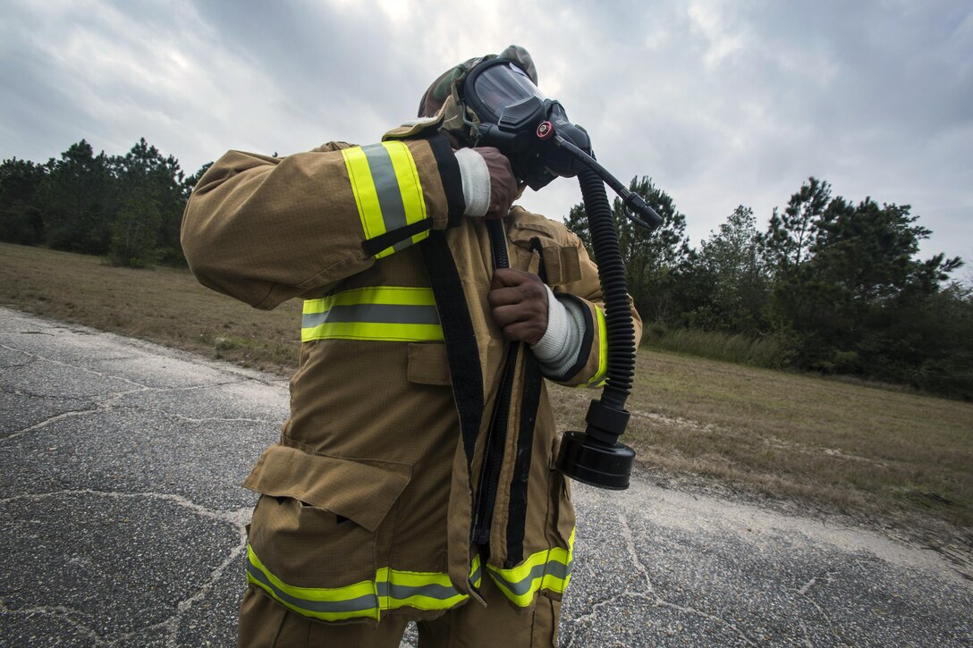 Staff Sgt. Denton Gladden, a firefighter with the 514th Civil Engineer Squadron, zips up his Mission-Oriented Protective Posture gear during a Chemical, Biological, Radiological and Nuclear exercise at the Combat Readiness Training Center at Gulfport, Mississippi, in support of Crisis Response 2017 March 7, 2017. Close to 700 AMC Airmen from the 514th Air Mobility Wing, 305th Air Mobility Wing, 87th Air Base Wing, and the 621st Contingency Response Wing at Joint Base McGuire-Dix-Lakehurst, N.J., are participating in the mobilization exercise Crisis Response 2017. The primary goal of this exercise is for the four wings to deploy to an austere location and set up and sustain combat air mobility operations. (U.S. Air Force photo by Master Sgt. Mark C. Olsen/Released)