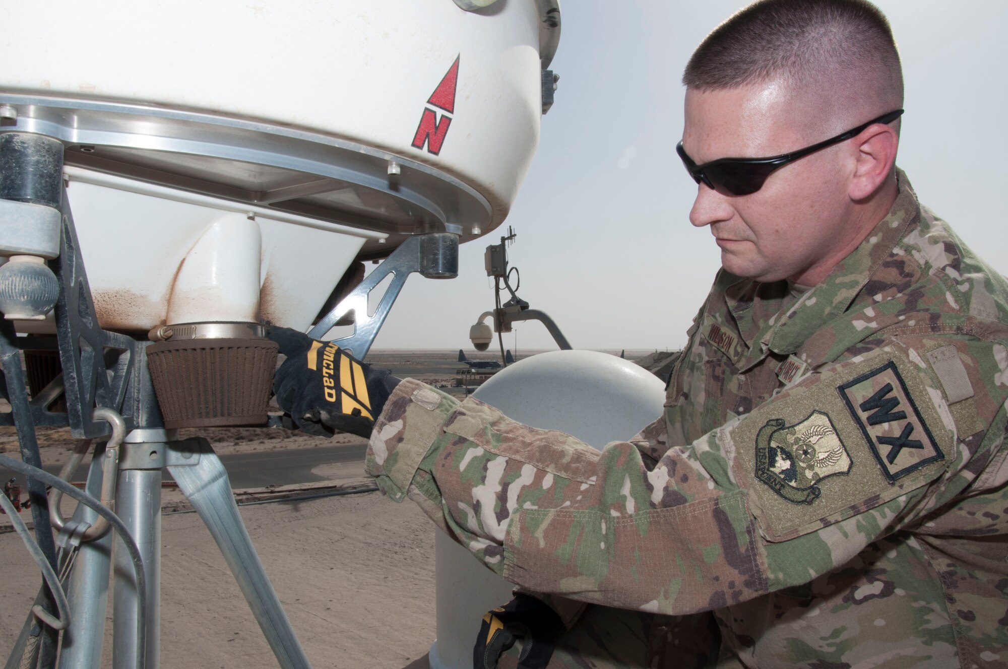 Tech. Sgt. Keith Wilson inspects dust filer of a portable Doppler radar unit during a preventative maintenance inspection at an undisclosed location in southwest Asia, June 11, 2017. Excessive dust inside the Doppler can cause the unit to overheat and possibly fail. (U.S. Air Force photo/Master Sgt. Eric M. Sharman)