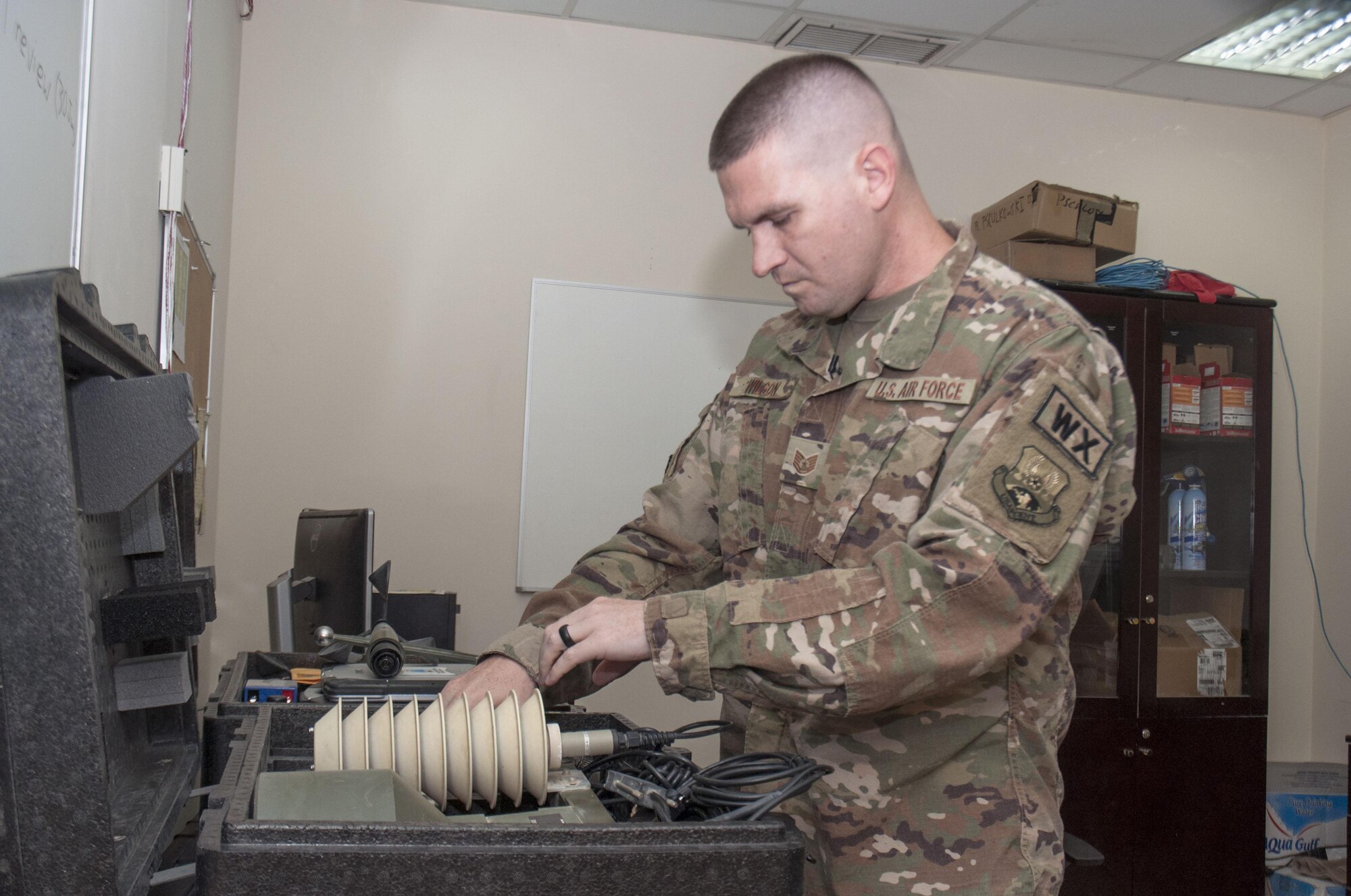 Tech. Sgt. Keith Wilson inspects the TMQ-53 tactical weather system at an undisclosed location in southwest Asia Sunday, June 11, 2017. Wilson uses this and other equipment to provide constant weather updates in support of a wide array of base operations. (U.S. Air Force photo/Master Sgt. Eric M. Sharman)