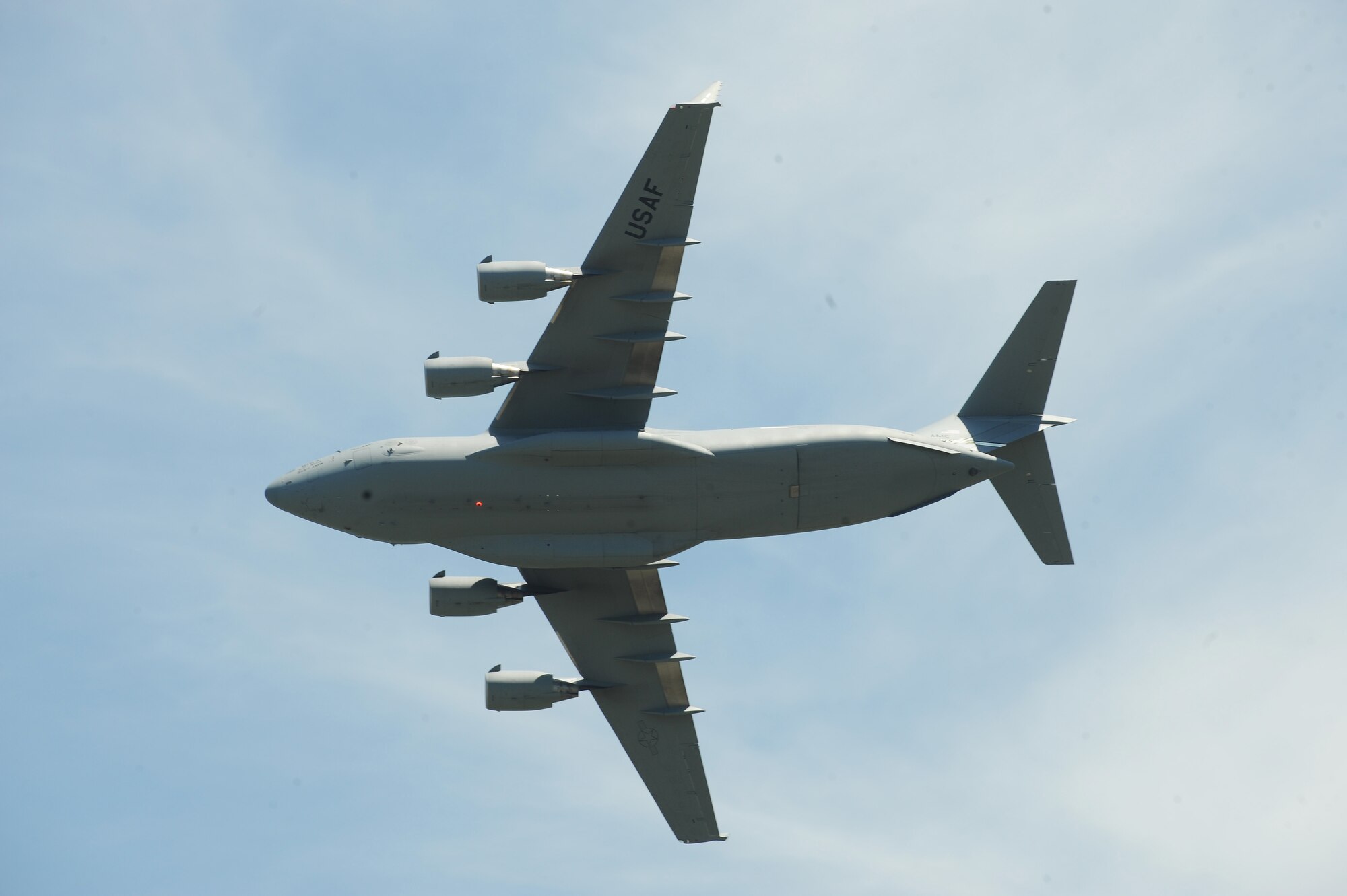A 15th Wing C-17 Globemaster III conducts a fly-by during the Scott Air Force Base 2017 Air Show and Open House June 10, which celebrates the base’s 100th anniversary.  The aircraft is normally operated by a crew of three people: pilot, co-pilot and loadmaster. Cargo is loaded onto the C-17 through a large aft door that accommodates military vehicles and palletized cargo.  The aircraft can take off and land on runways as short as 3,500 feet long and only 90 feet wide. (U.S. Air Force photo by Tech. Sgt. Maria Castle)