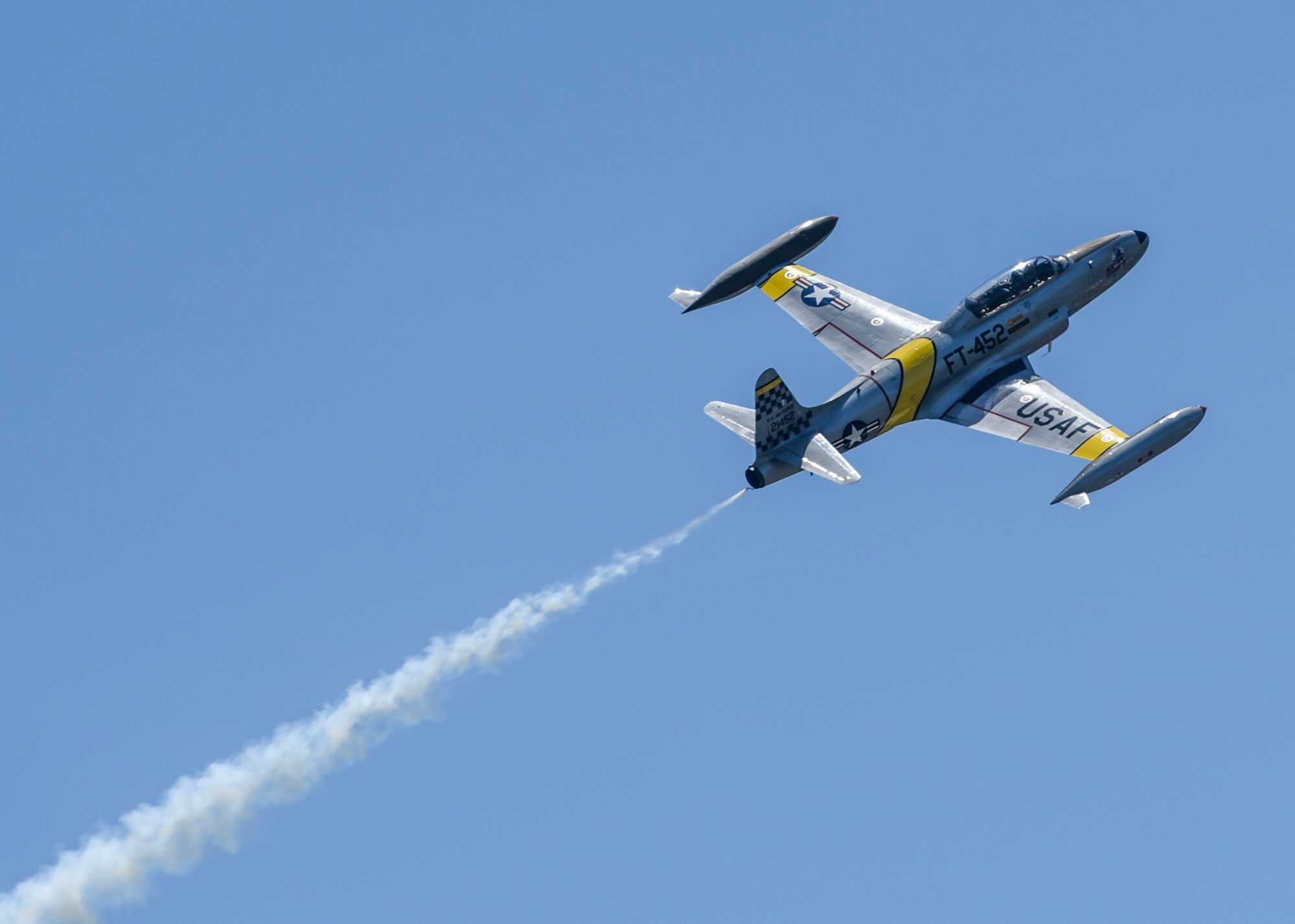 Gregory Colyer demonstrates combat maneuvers in the T-33 during the 100th Centennial Celebration Air Show, June 10, 2017, at Scott Air Force Base, Ill.  The two-place T-33 jet was designed for training pilots already qualified to fly propeller-driven aircraft. It was developed from the single-seat F-80 fighter by lengthening the fuselage about three feet to accommodate a second cockpit. (U.S. Air Force photo by Staff Sgt. Jodi Martinez)